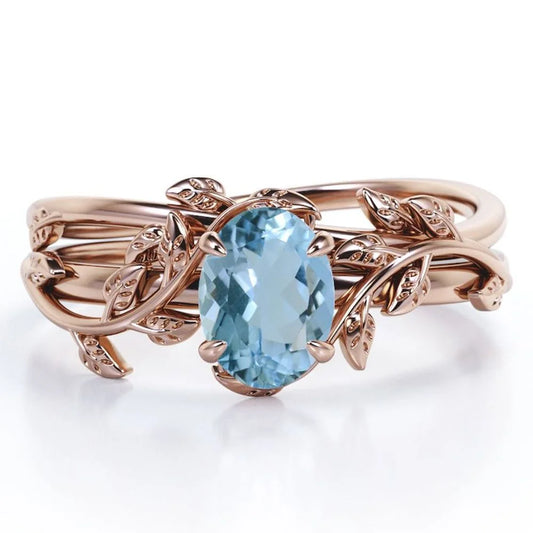 Four Prong Set 1.3 Carat Oval Shaped Light Blue Created Aquamarine Vine Leaf Design Wedding Set in 18K Rose Gold Plating over Silver
