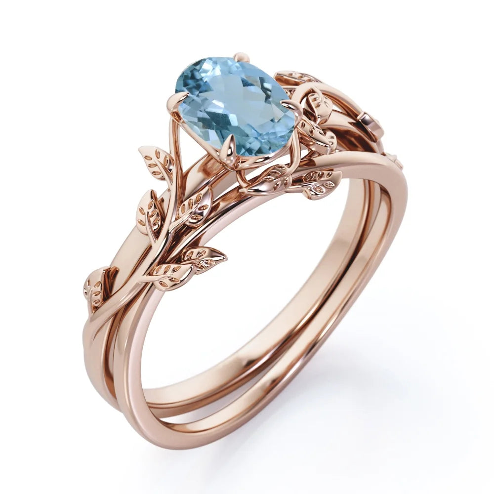 Four Prong Set 1.3 Carat Oval Shaped Light Blue Created Aquamarine Vine Leaf Design Wedding Set in 18K Rose Gold Plating over Silver